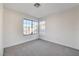 Well-lit bedroom featuring a large window and neutral carpeting at 759 Whispering Palms Dr, Las Vegas, NV 89123