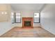 Living room with brick fireplace and wood flooring at 759 Whispering Palms Dr, Las Vegas, NV 89123