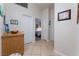 Well-lit hallway with tile flooring and access to bedrooms at 848 Waterloo Dr, Henderson, NV 89002