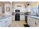 Bright kitchen with white cabinets, black appliances, and granite countertops at 848 Waterloo Dr, Henderson, NV 89002