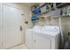 Bright laundry room features washer, dryer, and ample shelving at 848 Waterloo Dr, Henderson, NV 89002