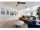 Living room with a brown leather couch, a round coffee table, and gallery wall at 848 Waterloo Dr, Henderson, NV 89002