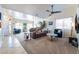 Spacious living room featuring a leather sectional sofa, large windows, and neutral carpeting at 848 Waterloo Dr, Henderson, NV 89002