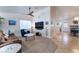 Living room with a brown couch, a blue armchair, and a view into the dining area at 848 Waterloo Dr, Henderson, NV 89002