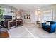 Open living area with a brown couch, a blue armchair and a long console table at 848 Waterloo Dr, Henderson, NV 89002