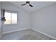 Bedroom with large window, ceiling fan and wood-look floors at 8517 Soneto Ln, Las Vegas, NV 89117