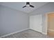 Bright bedroom features ceiling fan and double door closet at 8517 Soneto Ln, Las Vegas, NV 89117