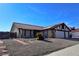 Single-story house with red tile roof and two-car garage at 8517 Soneto Ln, Las Vegas, NV 89117