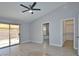 Main bedroom with ceiling fan, access to bathroom and walk-in closet at 8517 Soneto Ln, Las Vegas, NV 89117