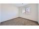 Well-lit bedroom with neutral carpeting and window at 8633 Portofino Ct, Las Vegas, NV 89117