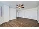 Bright bedroom with wood-look flooring and ample closet space at 8633 Portofino Ct, Las Vegas, NV 89117