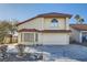 Tan two-story house with tile roof, two-car garage, and desert landscaping at 8633 Portofino Ct, Las Vegas, NV 89117