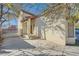 Front entrance of a two-story house with a walkway and gate at 8633 Portofino Ct, Las Vegas, NV 89117