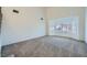 Bright living room with bay window, carpet, and staircase at 8633 Portofino Ct, Las Vegas, NV 89117