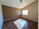 Bright bedroom featuring wood-look floors and large window at 865 Gleamstar Ave, Las Vegas, NV 89123