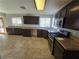 Kitchen features dark wood cabinets, granite counters, and stainless steel appliances at 865 Gleamstar Ave, Las Vegas, NV 89123