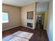 Living room with fireplace and wood-look floors at 865 Gleamstar Ave, Las Vegas, NV 89123