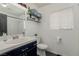 Well-lit bathroom with floating shelves, modern vanity, and shower at 8986 Lillyhammer Ct, Las Vegas, NV 89147