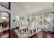 Elegant dining room with hardwood floors, a glass table, and white chairs at 8986 Lillyhammer Ct, Las Vegas, NV 89147