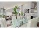 Spacious dining area with hardwood floors, glass-top table, and white chairs at 8986 Lillyhammer Ct, Las Vegas, NV 89147