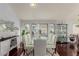 Elegant dining room with hardwood floors, large windows, and a glass-top dining table at 8986 Lillyhammer Ct, Las Vegas, NV 89147