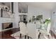 Bright dining room with hardwood floors, glass table, and white leather chairs at 8986 Lillyhammer Ct, Las Vegas, NV 89147