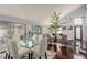 Bright dining room features a glass table with white chairs and hardwood floors at 8986 Lillyhammer Ct, Las Vegas, NV 89147