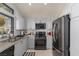 Modern kitchen with gray cabinets, granite countertops, and stainless steel appliances at 8986 Lillyhammer Ct, Las Vegas, NV 89147