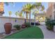 Landscaped backyard with artificial turf and large pots at 8986 Lillyhammer Ct, Las Vegas, NV 89147