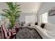 Living room with hardwood floors, white couch, and a large potted plant at 8986 Lillyhammer Ct, Las Vegas, NV 89147