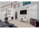 Two-story living room featuring a modern entertainment center and comfortable seating at 8986 Lillyhammer Ct, Las Vegas, NV 89147