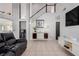 Living room with hardwood floors, staircase, and contemporary decor at 8986 Lillyhammer Ct, Las Vegas, NV 89147