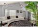 Living room with hardwood floors, white couch, and a large potted plant at 8986 Lillyhammer Ct, Las Vegas, NV 89147