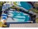 Aerial view of kidney-shaped pool with surrounding patio and palm trees at 8986 Lillyhammer Ct, Las Vegas, NV 89147