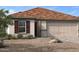 One-story home with brown tile roof, beige siding, and dark brown shutters at 9189 Oakdale Ranch Ct, Las Vegas, NV 89139