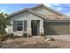 One-story home with stone accents and a two-car garage at 9195 Oakdale Ranch Ct, Las Vegas, NV 89139