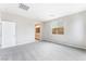 Bright bedroom featuring plush gray carpeting, white trim, and a view to the community at 9247 Lunar Phase St, Las Vegas, NV 89143