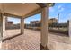 The covered patio features a brick base, neutral painted support beams, and a view of the backyard at 9247 Lunar Phase St, Las Vegas, NV 89143