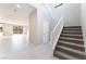 Welcoming entryway with tile flooring, staircase, and ample natural light, leading to the living area at 9247 Lunar Phase St, Las Vegas, NV 89143