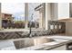 Close-up of a stainless steel kitchen sink with a chrome faucet and herringbone tile backsplash at 9247 Lunar Phase St, Las Vegas, NV 89143