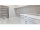 The laundry room provides ample storage with white shelving and a countertop, making laundry tasks more efficient at 9247 Lunar Phase St, Las Vegas, NV 89143