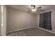 Carpeted bedroom with ceiling fan and window treatments at 9428 Noble Fir Ridge Ave, Las Vegas, NV 89143