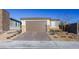 Modern single story house with a brown garage door and brick driveway at 9428 Noble Fir Ridge Ave, Las Vegas, NV 89143