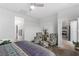 Bedroom with two armchairs and a view of the kitchen at 9465 White Fir Grove Ct, Las Vegas, NV 89143