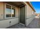 Side entrance with a dark green door and brick walkway at 9465 White Fir Grove Ct, Las Vegas, NV 89143