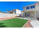 Landscaped backyard with artificial turf and patio at 9541 Summersweet Ct, Las Vegas, NV 89123