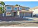 Two-story house with a three-car garage and landscaped front yard at 9541 Summersweet Ct, Las Vegas, NV 89123