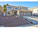 Two-story house with a three-car garage and landscaped front yard at 9541 Summersweet Ct, Las Vegas, NV 89123