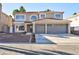 Two-story house with a three-car garage and landscaped front yard at 9541 Summersweet Ct, Las Vegas, NV 89123