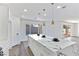 Modern kitchen with white cabinets, marble island, and pool view at 9541 Summersweet Ct, Las Vegas, NV 89123